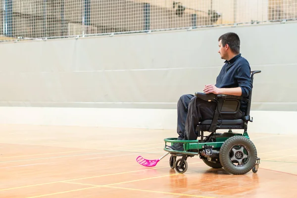 Disabled man on an electric wheelchair playing sports, powerchair hockey. IWAS - International wheelchair and amputee sports federation — Stock Photo, Image