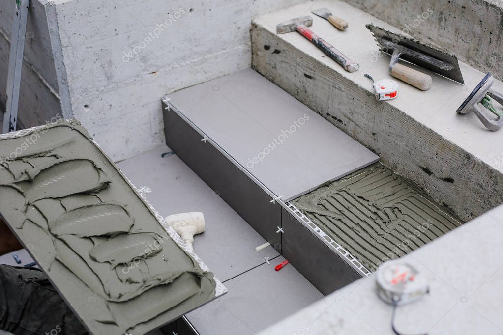 Laying New Tiles On A Concrete Steps Outside Of Building 300197818 Larastock - How To Lay Tiles On Concrete Steps Laying New Tiles On A Concrete Steps Outside Of Building 300197818 Larastock - How To Lay Tiles On Concrete Steps