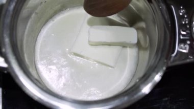 Aşırı esmerleşme olmayan sopa tava tava ağır çekimde, yemek pişirmek için hazırlık içinde erime tereyağı küp