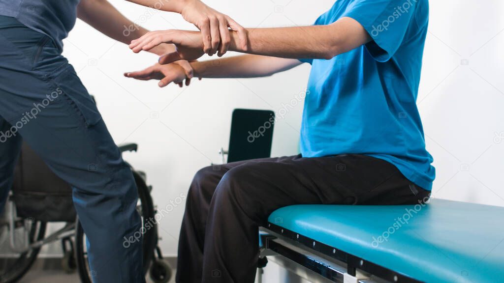 Physiotherapist with disabled person