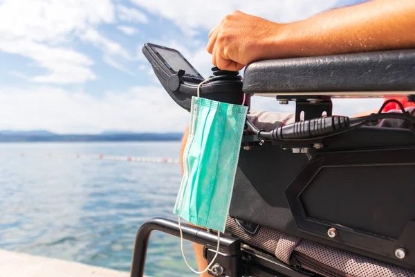 Face mask on a wheelchair — Stock Photo, Image