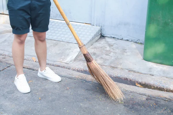 Sweeping the sidewalk stock fotografie, royalty free Sweeping the sidewalk  obrázky | Depositphotos