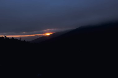 Yüksek dağlar ve geniş vahşi ormanlar arasında güzel günbatımı