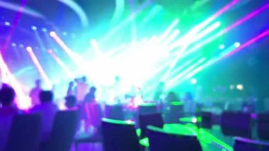 Gece kulübünde parlak ışıklar, diskoda ışık huzmeleri. İzleyen bir kalabalığın olduğu yeşil bir sahne. Sahne parlak ışıklarla aydınlanıyor. Sahnede birkaç kişi var.