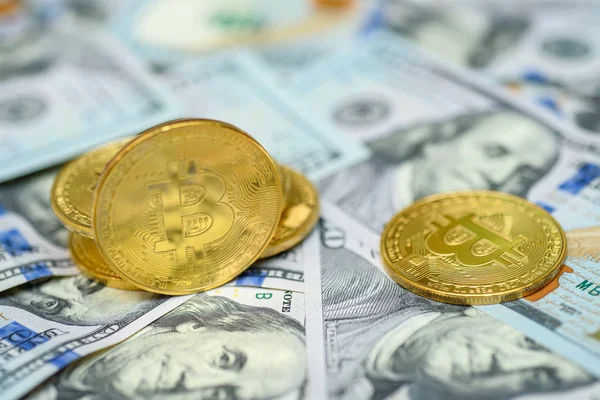 Birkaç yüz dolar faturaları arka plan üzerinde döşeme altın bitcoin paraları 
