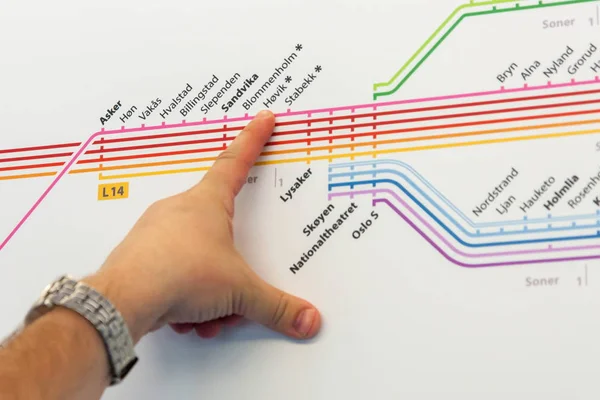 Men's hand gesture pointing the way on the subway scheme, Norway — Stock Photo, Image