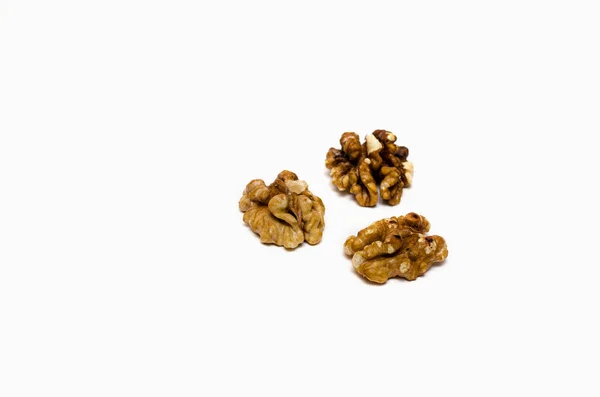 Three walnuts partially out of focus on white background, with a place for the text — Stock Photo, Image