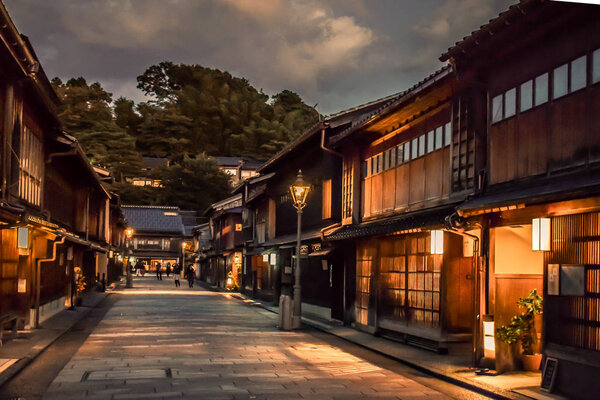 Traditional Japanese street with old wooden houses in Kanazawa Japan during sunset