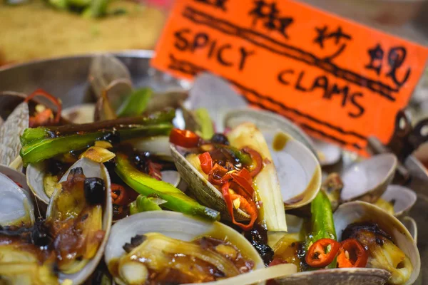 Plate with spicy clams sold on a night market in Hong Kong China