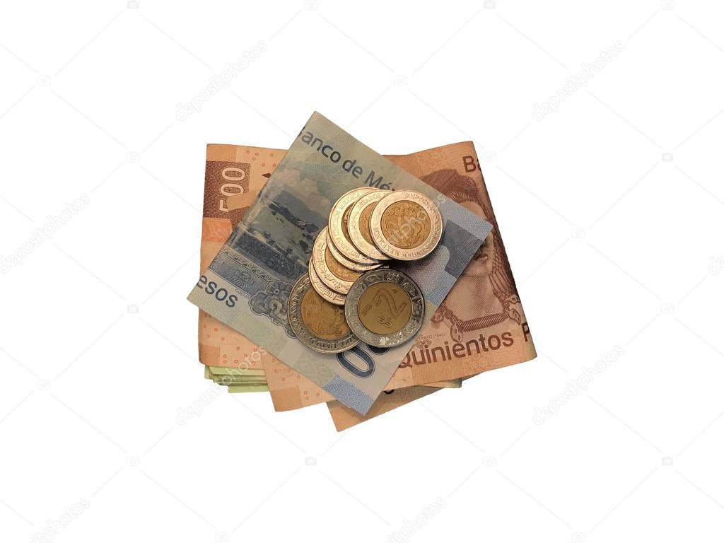 Various mexican coins on top of some peso bills of 100, 200 and 500 folded and grouped isolated on white background