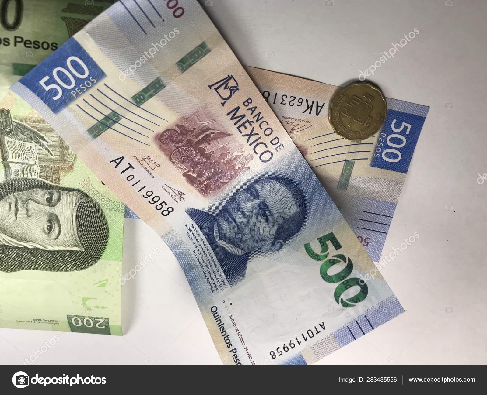 Mexican peso bills spread over white background — Stock Photo ©  andresjabois #283435556