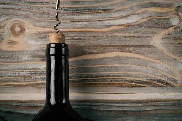 Opening wine bottle with a corkscrew art