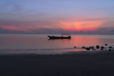 Silhouette of fisherman boat at Atauro Island, Timor Leste during sunrise clipart