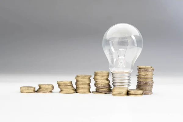Light Bulb with coins, money ideas concept