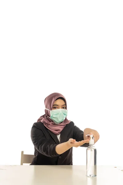 Business Lifestyle, Cute Malay Woman wearing hijab, face mask using sanitizer