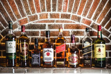 Johnnie Walker Black Label and Red Label, Jameson, Jack Daniels, Grants, Chivas Regal, The Macallan and Jim Beam whiskey bottles. Famous brands whiskey in world