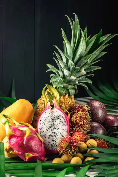 Set of exotic fruits. Assorted tropical fruits of pineapple, rambutan, passion fruit, mango, dragon fruit, longan