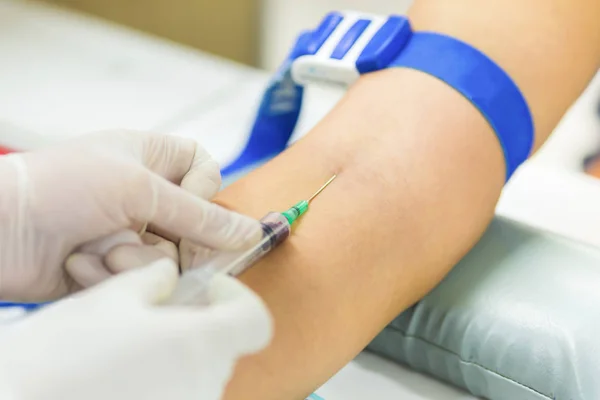 Medical technologist doing a blood draw services for patient.