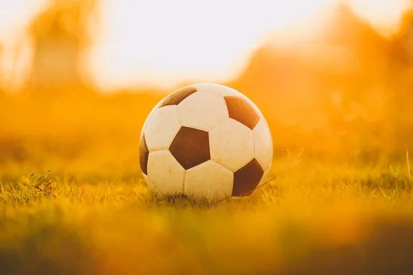 A ball for street soccer football under the sunset ray light. Film picture style.