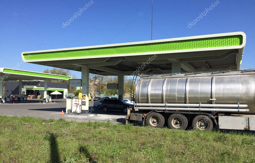 Gas station with gasoline prices and tanker in the city of Ukraine. Fuel station sign.