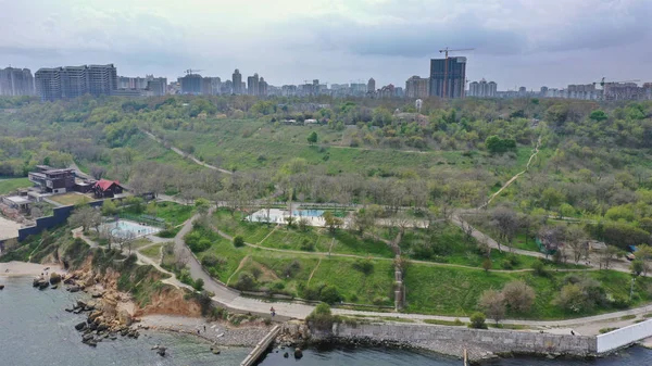 Bird\'s-eye view of the embankment of the sea city with a big park near the sea.