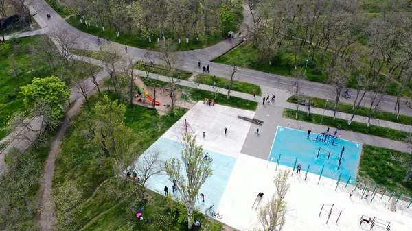 Bird\'s-eye view of the sports field with people involved in sports in the park