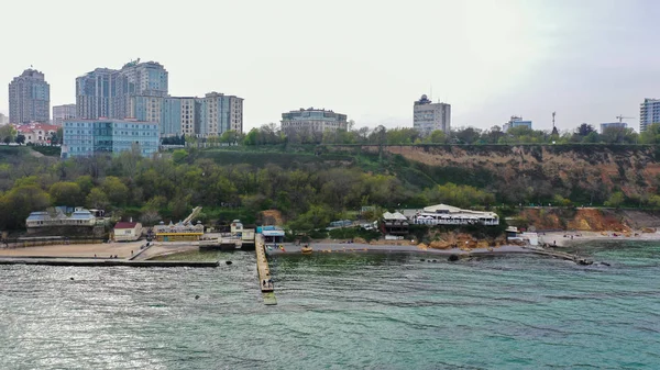 Bird\'s-eye view of the embankment of the sea city with a big park near the sea.