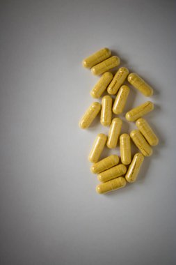 Masaya saçılmış sarı haplar