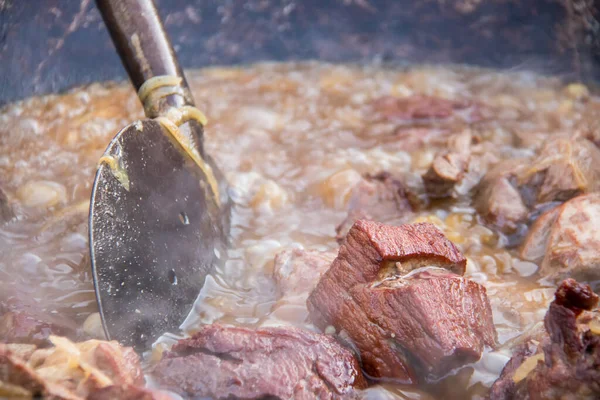 juicy cuts of meat in boiling oil
