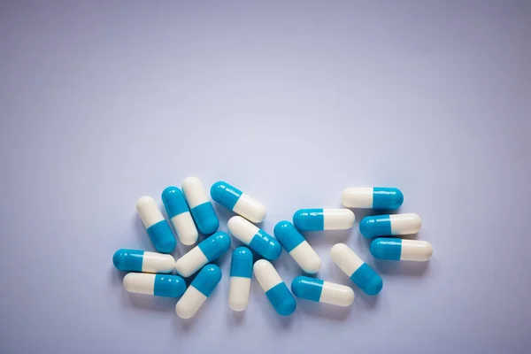 blue-white pills on a plain background