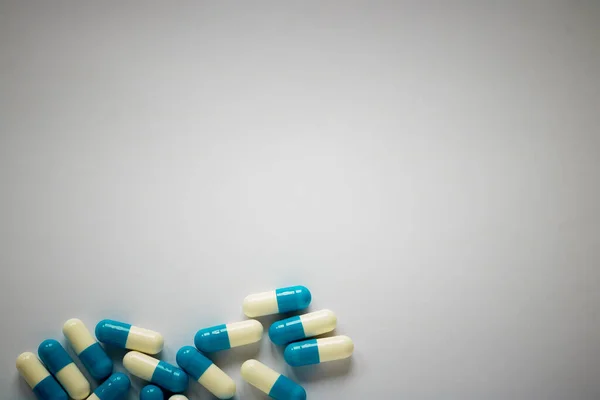 blue-white pills on a plain background