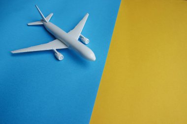 Mavi ve sarı zemin üzerine beyaz uçak boşaltmak