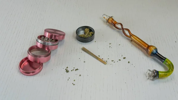 Marijuana joint, buds, grinder and smoking pipe are on the white — Stock Photo, Image