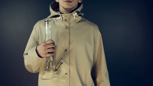 The young person smoking medical marijuana with bong.