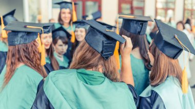 Bir grup genç kadın mezun. Kadın mezun ag gülümsüyor