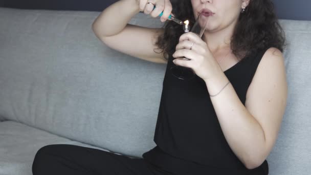 年轻人在室内吸食医用大麻 那个年轻女子在家里吸食大麻 大麻是草药的概念 — 图库视频影像