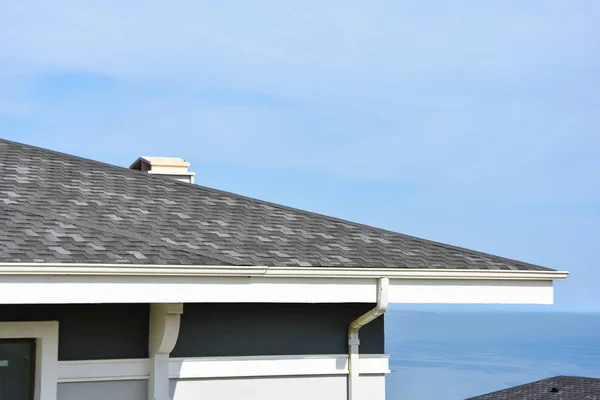 Asphalt roofing shingles, sky background