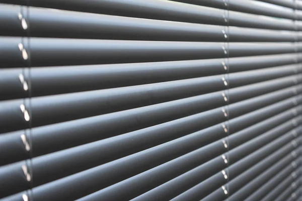 Closed metal blinds, sunlight reflection