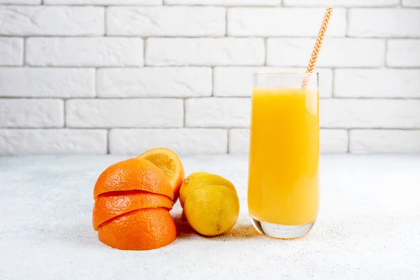 Beyaz masaya taze portakal ve limon suyu. Ev yapımı narenciye suyu. Sağlıklı gıda, beslenme ve antioksidan kavramı
