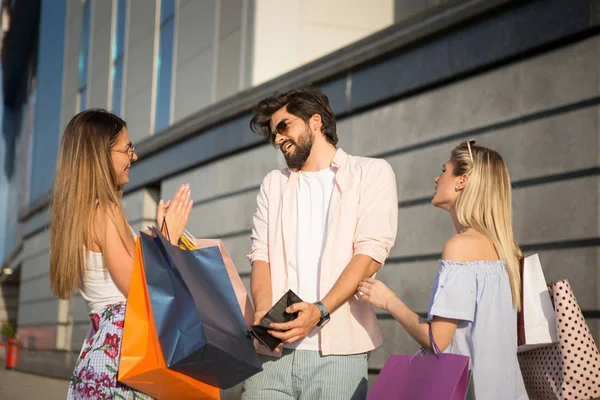 He\'s sad because he spent all his money, But his girlfriend wants more money for shopping.