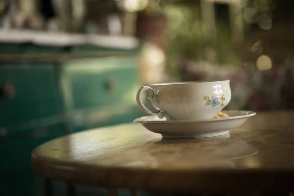 An old cup of tea on the table.