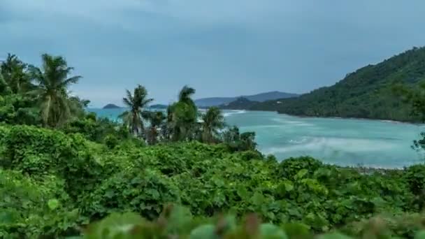 Tropical palm trees stagger from the wind against the background of the sea and mountains of Koh Samui, Thailand. Timelapse 4K — Stock Video