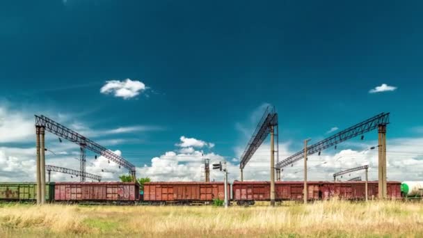 Freight railroad hopper train at the background clouds. Timelapse 4K — Stock Video