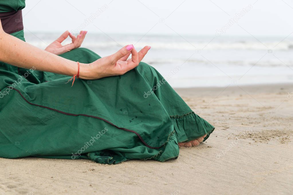 girl in yoga pose by the water