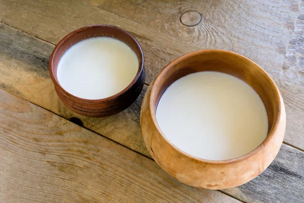 stock image fresh milk in a wooden bowl on the table