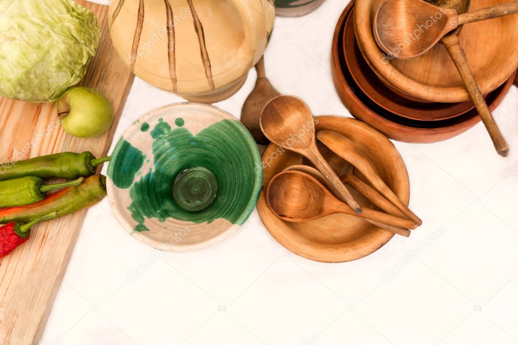 clay and wooden utensils on a white background
