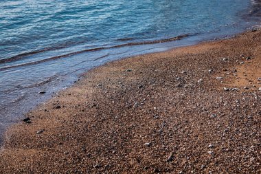 Kumlu ve kayalık Plajı mavi deniz dalga yumuşak