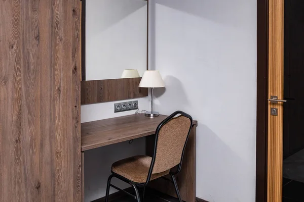 Workplace, table with lamps and sockets, in the apartment, hotel