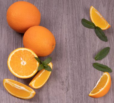 Portakal bütün ve nane yaprakları kesilmiş bir ahşap doku backgroun