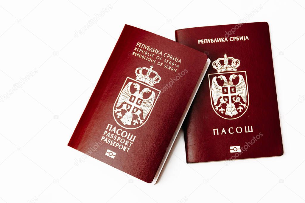 Two version of biometric Serbian passport, old and new, isolated on white background